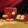 Box of JU Signatures Flaky Teochew Orh Nee mooncakes, four whole and two halved showing yam and salted egg yolk filling